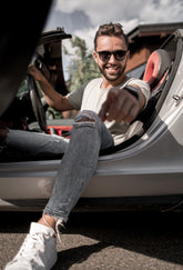 Man getting into a car with a relaxed posture
